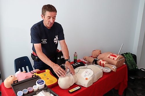 Louis Riel College first aid instructor Gerry Desjardin demonstrates how to apply an oxygen mask to a practice dummy during the official opening of the school's 200 Main St. campus on July 29, 2026 (Tyler Searle / Winnipeg Free Press).