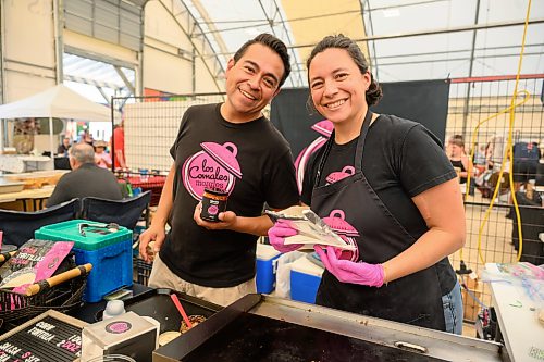 Mike Sudoma / Free Press
Los Compales Morales owners Eduardo and Helena Morales show off their hot sauce and an order of quesadillas featuring their corn tortillas at their booth inside the St Norbert Farmers Market Saturday morning
July 25, 2026