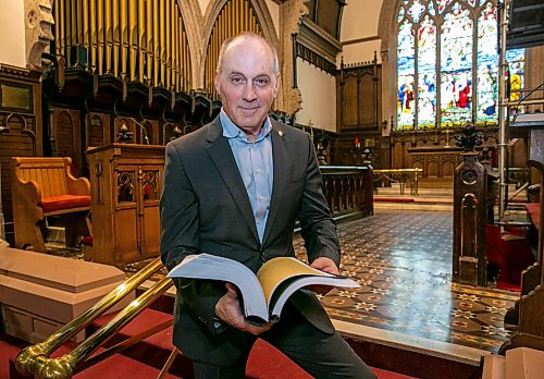 BROOK JONES/FREE PRESS
Holy Trinity Anglican Church and CentreVenture Development Corporation officially launch Phase II of the Holy Trinity Heritage Renewal Initiative, a major planning process that will help shape the future of one of Winnipeg's most significant heritage landmarks, on Wednesday, July 29, 2026. Pictured: Stephen Borys, who is the President & CEO of Civic Muse Inc. and building project manager of Holy Trinity Anglican Churh, looking through the first volumn of the Building Assessment and Heritage Condition Report while standing on sanctuary steps at Holy Trinity Church in Winnipeg, Man.