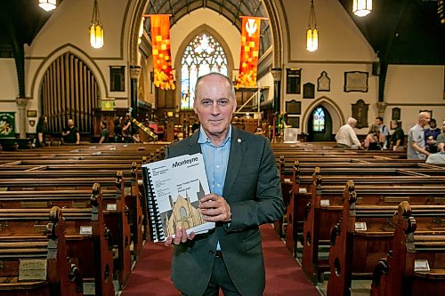 BROOK JONES/FREE PRESS
Holy Trinity Anglican Church and CentreVenture Development Corporation officially launch Phase II of the Holy Trinity Heritage Renewal Initiative, a major planning process that will help shape the future of one of Winnipeg's most significant heritage landmarks, on Wednesday, July 29, 2026. Pictured: Stephen Borys, who is the President & CEO of Civic Muse Inc. and building project manager of Holy Trinity Anglican Churh, holding the first volumn of the Building Assessment and Heritage Condition Report while standing in the nave at Holy Trinity Church in Winnipeg, Man.