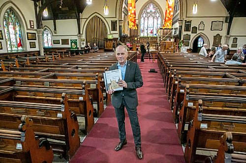 BROOK JONES/FREE PRESS
Holy Trinity Anglican Church and CentreVenture Development Corporation officially launch Phase II of the Holy Trinity Heritage Renewal Initiative, a major planning process that will help shape the future of one of Winnipeg's most significant heritage landmarks, on Wednesday, July 29, 2026. Pictured: Stephen Borys, who is the President & CEO of Civic Muse Inc. and building project manager of Holy Trinity Anglican Churh, holding the first volumn of the Building Assessment and Heritage Condition Report while standing in the nave at Holy Trinity Church in Winnipeg, Man.