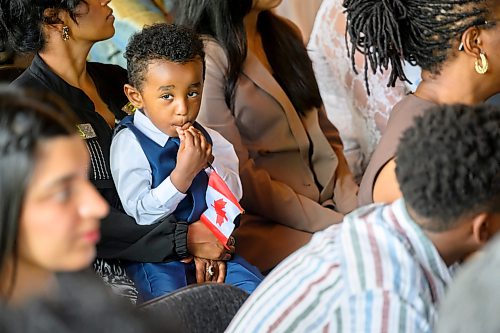 Mike Sudoma/Free Press
Tbeb Okube gets ready to cheer on his dad Yosief Okube as he receives his Canadian Citizenship during a ceremony at The Forks Wednesday morning
July 29, 2026