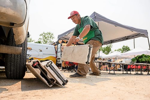Mike Sudoma / Free Press
Tom Wang of Fertile Farms folds up a few tables as he gets ready to leave a bit early as he was almost fully sold out by 130pm Saturday afternoon 
July 25, 2026