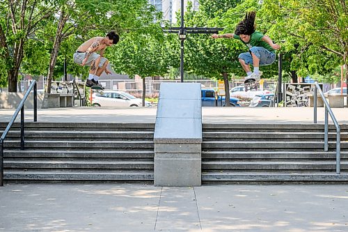 Mike Sudoma/Free Press
(Left to right) Austin Baran and Issiah Parsian double up with Ollies down the 6 stair obstacle at The Forks Plaza Skatepark Wednesday afternoon
July 29, 2026
