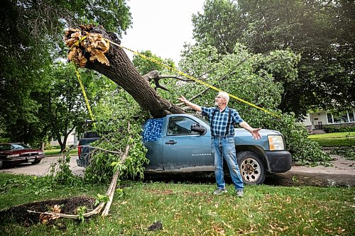 MIKAELA MACKENZIE / FREE PRESS
Jake Falk shows a tree that fell on his truck during the storm on Stewart Street on Thursday, July 30, 2026.
For Chris story.
Free Press 2026