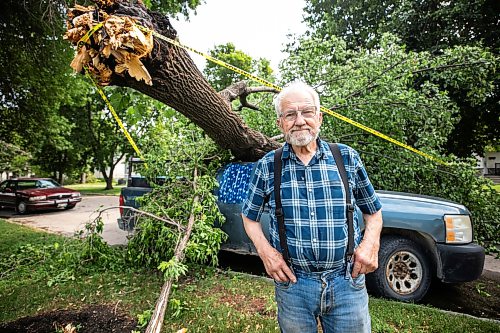 MIKAELA MACKENZIE / FREE PRESS
Jake Falk shows a tree that fell on his truck during the storm on Stewart Street on Thursday, July 30, 2026.
For Chris story.
Free Press 2026
