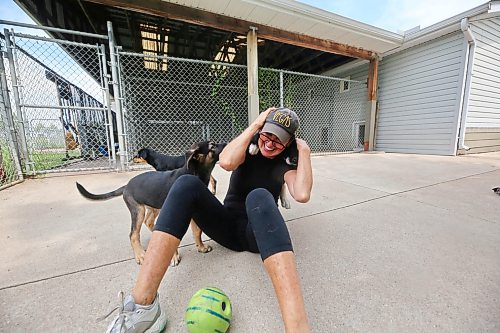 Brandon Humane Society director Tracy Munn plays with puppies Khaleesi, Sansa and Aria on a warm summer Thursday afternoon at the society’s outdoor enclosure for a bit of exercise. (Matt Goerzen/The Brandon Sun)