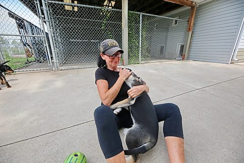 Brandon Humane Society director Tracy Munn holds Sansa, a playful puppy who is housed at the shelter, on a warm summer Thursday afternoon at the society’s outdoor enclosure. (Matt Goerzen/The Brandon Sun)