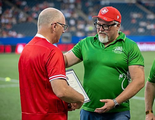 BROOK JONES/FREE PRESS
Rugby Canada honours the Winnipeg Wanderers Rugby Football Club's 100th anniversary during halftime of the match beween the Canadian men’s rugby union and Zimbabwe at Princess Auto Stadium in Winnipeg, Man., Saturday, July 18, 2026. Pictured: Winnipeg Mayor Scott Gillingham presents Wanderers President Brad Hirst with the City of Winnipeg Community Service Award. Also pictured is Wanderers Vice President Dan Fardoe.