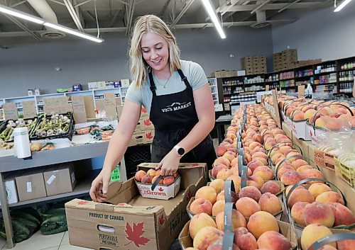 Ruth Bonneville / Free Press

ENT  Vic's market

Sierra  Schriemer, daughter of owner, setting out more baskets of Canadian peaches Friday. 

Story  Fresh fruit and veg at Vic’s Market, : Where to buy seasonal local produce.

Story by AV Kitching

July 31st,  2026