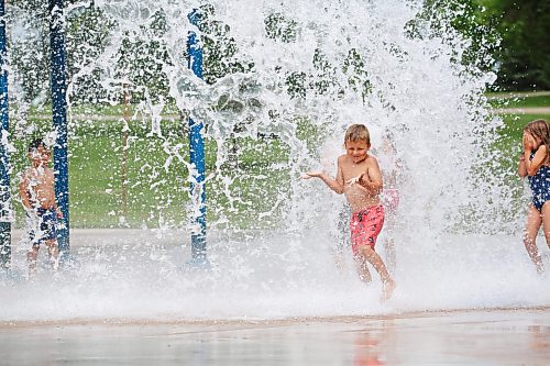 A young boy gets doused with water from the giant dump bucket at the Rideau Park Splash Pad on a pleasantly warm Friday afternoon. (Matt Goerzen/The Brandon Sun)
