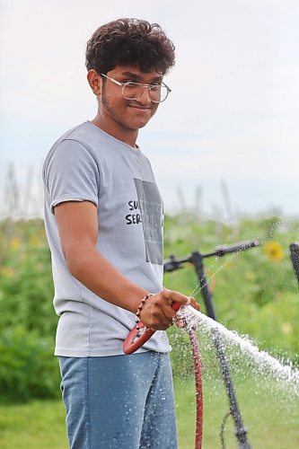 Gardner Prince Patel waters his plants at the Humming Bird Community Garden on 26th Street on Friday afternoon. (Matt Goerzen/The Brandon Sun)