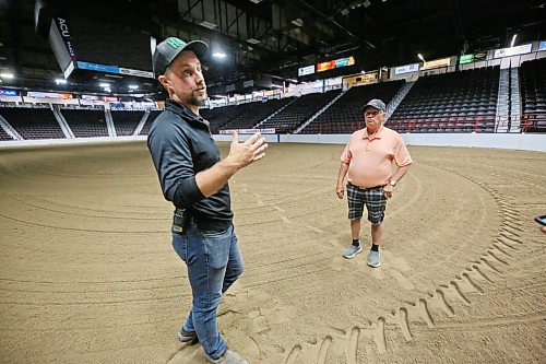Devin Epp, Agricultural sales and event manager for the Keystone Centre, right, together with footing technician Allan Quast from Lacombe, AB, explain how the facility readies the arena floor for Canada’s National Arabian Championship which starts next week Thursday here in Brandon. (Matt Goerzen/The Brandon Sun)