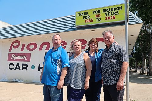 Aurora Video Audio general manager Walter Kosior (left), finance officer Lisa Kosior (second left), vice president Charlene Thompson, and president Jacob Kosior stand beside the store on Saturday afternoon. Aurora Video Audio is permanently closing its doors, ending an era for local electronics repair after six decades of repairing televisions and serving generations of customers in Brandon and Westman. (Abiola Odutola/The Brandon Sun)