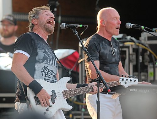 Chris Burke-Gaffney of Orphan and The Pumps, who also plays bass with Harlequin, sings Orphan's hit "Miracle" in front of Harlequin keyboardist Gary Golden during Rockin’ the Fields of Minnedosa on Sunday. (Perry Bergson/The Brandon Sun)
