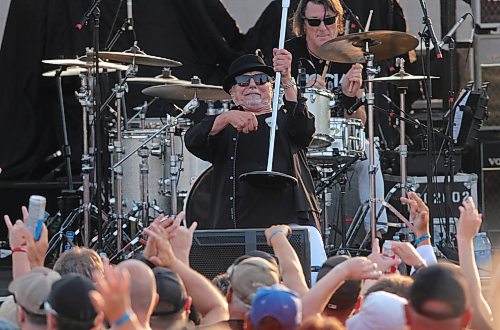 Harlequin lead singer George Belanger uses the mic stand as a fishing rod during Rockin’ the Fields of Minnedosa on Sunday. (Perry Bergson/The Brandon Sun)