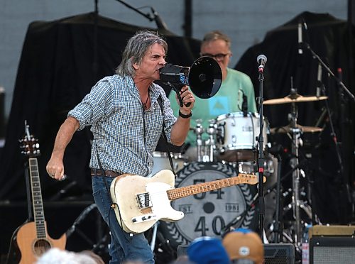 54-40 singer and guitarist Neil Osborne sings into a bullhorn in front of drummer Matt Johnson during Rockin’ the Fields of Minnedosa on Sunday. (Perry Bergson/The Brandon Sun)