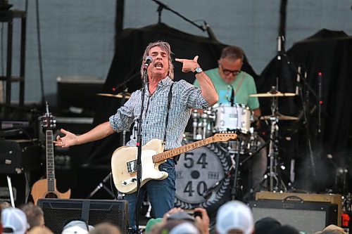 54-40 singer and guitarist Neil Osborne gestures in front of drummer Matt Johnson during Rockin’ the Fields of Minnedosa on Sunday. (Perry Bergson/The Brandon Sun)