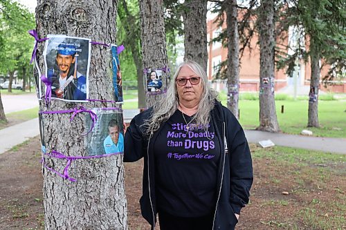 Antoinette Gravel-Ouellette was among a group of volunteers who put up nearly 170 photos over the weekend of Manitobans who have died of substance use. The photos are displayed on trees in Coronation Park in Brandon. (Tessa Adamski/The Brandon Sun)