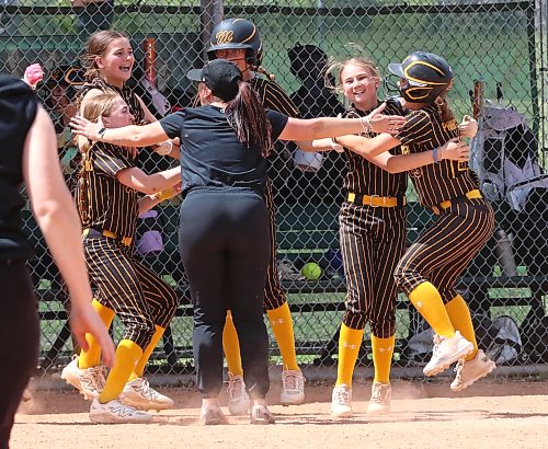Westman Magic head coach Heidi Figol and some of her players celebrate immediately after beating the Saskatoon Raiders 14-7 in the under-13 final of the Wheat City Classic at the Ashley Neufeld Softball Complex on June 14. The  Magic were the first Westman team to win gold at the annual event. (Perry Bergson/The Brandon Sun)

