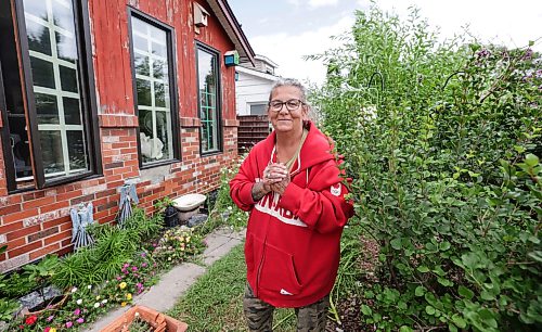 Ruth Bonneville / Free Press
Ava Tassos is elated that she was able to catch an injured fox in her frontyard after over two months of trying to get it help. Photo of Ava in front of her home.
Sked: Front YARD FOX RESCUE: After two months after trying to rescue an injured fox in her backyard, Ava Tasso finally saw success with the help of Paul Karnafel from The DogFather Rescue. The fox has mange in its hips and Tasso frequently saw the animal walking around injured in her community. She has a cat feeder for strays the fox would frequently eat from up to five times a day. The fox was given to Wildlife Haven, who told them the animal would be released after he recovers in three weeks.
Note: fox was captured in a cage made by The DogFather Rescue, in the front yard, where she is standing in the photo.
Aug 4th,, 2026