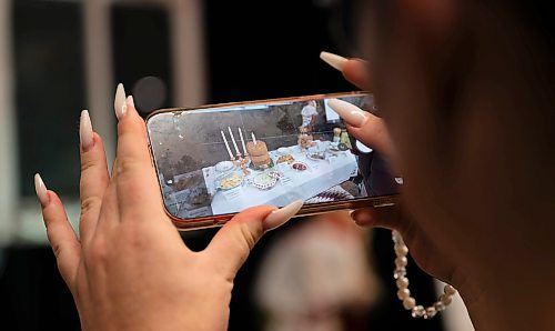 ROBERT LEE / FREE PRESS
A woman photographs some of the exhibits at the Ukraine Kyiv Pavilion for Folklorama on Tuesday, August 4, 2026 at Maples Collegiate in Winnipeg. People had the opportunity to learn about Ukrainian culture, including food, clothing and art.