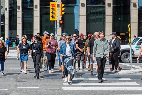 MIKE DEAL / FREE PRESS
Once crossing the street at Portage and Main became official huge crowds of people make their way around to each of the crosswalks.
The day of the official opening of the pedestrian crosswalks at the historic intersection of Portage Avenue and Main Street started with crews clearing away the last of the barriers and impatient people crossing despite those barriers.
The Mayor, Scott Gillingham and several city council members, along with may of the stakeholders for the buildings at each of the corners of the intersection were on hand with several hundred members of the public who cam to cheer and be some of the first to cross after the opening.
Dancing Gabe was on hand to lead a huge crowd around each of the intersections.
Reporter: Tyler Searle
250627 - Friday, June 27, 2025.