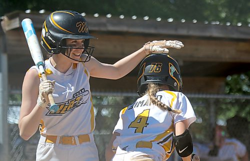 Brittyn DeVlieger of the Westman Heat steps up to bat while patting Bryelle Simard on the head following her run during a U15 AA softball showcase game earlier this season. The Heat head to provincials in Portage la Prairie this weekend. (Thomas Friesen/The Brandon Sun)