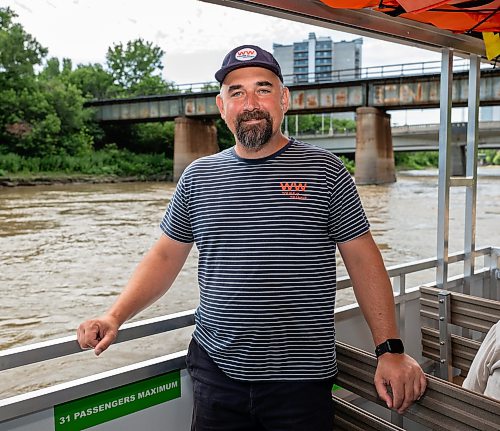 ROBERT LEE / FREE PRESS
Will Belford, co-owner of Winnipeg Waterways, poses with the new boat used for water bus service stationed at The Forks on Wednesday, August 5, 2026.