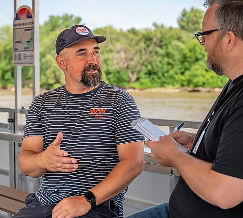 ROBERT LEE / FREE PRESS
Will Belford, co-owner of Winnipeg Waterways, speaks with Aaron Epp of the Free Press on the new boat used for water bus service stationed at The Forks on Wednesday, August 5, 2026.