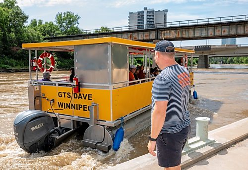ROBERT LEE / FREE PRESS
Will Belford, co-owner of Winnipeg Waterways, poses with the new boat used for water bus service stationed at The Forks on Wednesday, August 5, 2026.