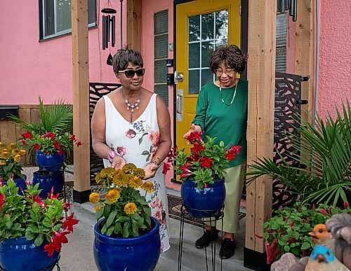 ROBERT LEE / FREE PRESS
Cherrlyn Thomson, left, and June James, both friends of Beryl Boney admire her award-winning garden outside Boney’s home on St. Mary's Road in Winnipeg, on Wednesday, August 5, 2026. Boney, who grew up in Trinidad and Tobago, has spent 25 years transforming the front and back of her block with flowers and vegetables, including ceramic chickens that nod to her Caribbean roots.