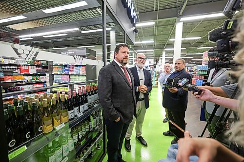 Ruth Bonneville / Free Press
BIZ - liquor mart
Story: Manitoba’s newest Liquor Mart opens with pick-up window only, inside Save-On-Foods at Northgate Shopping Centre, Thursday.
Story on the new approach to customer convenience and its pros and cons.
Photo of Glen Simard, Minister of Municipal and Northern Relations (left) and
Robert Holmberg, Executive Vice President, Liquor and Cannabis, Manitoba Liquor & Lotteries, answering questions from the media in front of the glass walls of the store.
See story by Gabby
Aug 6h,, 2026