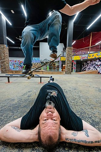ROBERT LEE / FREE PRESS
Fane Smeall, Pitikwe manager and skater, jumps over Roger West, security, at the Pitikwe Skatepark in downtown Winnipeg on Thursday, August 6, 2026. The indoor park, formerly in Portage Place, relocated earlier this year to a former Snap Fitness beside the APTN building, continuing the city’s tradition of skateboarders creating their own year-round hubs.
