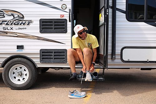 04082026
James Newman ties his shoes while preparing to run along the Trans Canada Highway west of Brandon on Tuesday as part of his goal to run across Canada in under 100 days. Newman is using his James Runs Canada run to raise money to support scholarships for youth through the Children’s Aid Foundation of Canada’s Post-Secondary Education Program.
(Tim Smith/The Brandon Sun)