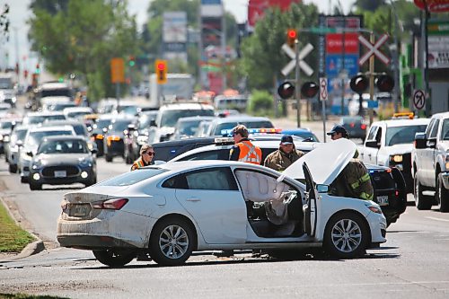 Traffic backs up in the northbound lane of 18th Street as emergency crews check the damage to one of two vehicles involved in a collision at the Park Avenue and 18th Street intersection on Friday during the noon hour. Airbags are clearly visible on the passenger side of the vehicle, though Brandon Police indicated later Friday afternoon that there were no known injuries as a result of the collision. (Matt Goerzen/The Brandon Sun)