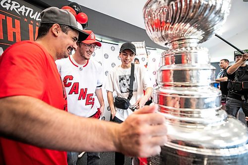 MIKAELA MACKENZIE / FREE PRESS
	
Seth Jarvis (left) interacts with fans Ardal Dane (centre) and Simon Marr with the Stanley Cup at the Tuxedo Community Centre on Monday, Aug. 10, 2026.

For Grace Penner story.
Free Press 2026