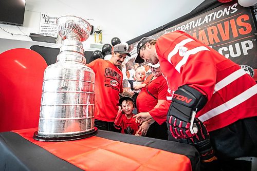 MIKAELA MACKENZIE / FREE PRESS
	
Emmett Snider, four, is overwhelmed with emotion while taking a photo with Seth Jarvis and the Stanley Cup at the Tuxedo Community Centre on Monday, Aug. 10, 2026. From left to right: Seth Jarvis, Emmett Snider (four), Lochlyn Snider (one), Barbara Chrismas, and Greg Snider

For Grace Penner story.
Free Press 2026