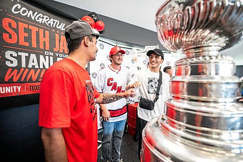 MIKAELA MACKENZIE / FREE PRESS
	
Seth Jarvis (left) interacts with fans Ardal Dane (centre) and Simon Marr with the Stanley Cup at the Tuxedo Community Centre on Monday, Aug. 10, 2026.

For Grace Penner story.
Free Press 2026