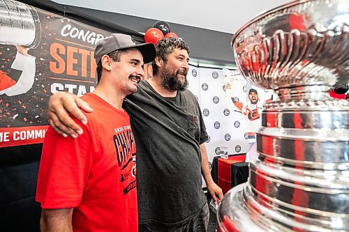 MIKAELA MACKENZIE / FREE PRESS
	
Chris Cochrene (right) takes a photo with Seth Jarvis and the Stanley Cup at the Tuxedo Community Centre on Monday, Aug. 10, 2026.

For Grace Penner story.
Free Press 2026