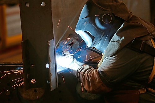 Heat from a welder illuminates an employee with Behlen Industries on Douglas Street on Monday afternoon. Behlen is manufacturing and supplying the pre-engineered buildings for Bell Canada’s massive 300 MW artificial intelligence data centre in Sherwood, Saskatchewan. As a result, the Brandon-based company has increased its production and invested in new equipment. (Matt Goerzen/The Brandon Sun)