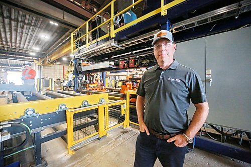 Clint Swain, regional sales manager with Behlen Industries on Douglas Street in Brandon, stands in front of a brand new seam and beam welder that just came online last week, representing a $6-million investment for the company. The new seam and beam welder is being utilized for Behlen’s contract with Bell Canada to manufacture and supply pre-engineered buildings for a massive 300 MW artificial intelligence data centre in Sherwood, Saskatchewan.  (Matt Goerzen/The Brandon Sun)