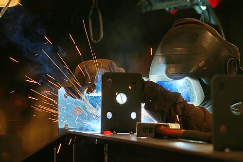 Heat from a welder illuminates an employee with Behlen Industries on Douglas Street on Monday afternoon. Behlen is manufacturing and supplying the pre-engineered buildings for Bell Canada’s massive 300 MW artificial intelligence data centre in Sherwood, Saskatchewan. As a result, the Brandon-based company has increased its production and invested in new equipment. (Matt Goerzen/The Brandon Sun)