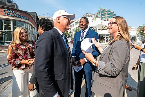 MIKAELA MACKENZIE / FREE PRESS
	
Mayor Scott Gillingham (left), business minister Jamie Moses, and Downtown Winnipeg BIZ CEO Kate Fenske chat after a press conference announcing new funding for downtown businesses on Tuesday, Aug. 11, 2026.

For Joyanne story.
Free Press 2026