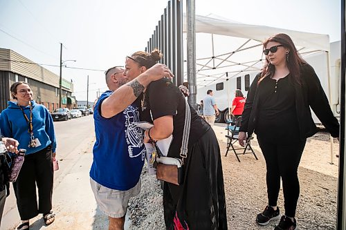 MIKAELA MACKENZIE / FREE PRESS
Jamil Mahmood, Main Street Project executive director (left), hugs Charlene Hallett, with the Aboriginal Health and Wellness Centre of Winnipeg, at the entrance of the supervised consumption site at 366 Higgins on Tuesday, Aug. 11, 2026.
For Malak story.
Free Press 2026