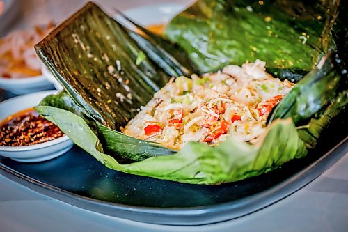 JOHN WOODS / FREE PRESS
Mama's chicken in banana leaf at House of Ma, a new Asian-fusion restaurant on Bannatyne  Tuesday, August 11, 2026. True Hospitality has opened a couple of new ventures on Bannatyne.

reporter: eva
