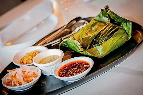 JOHN WOODS / FREE PRESS
Mama's chicken in banana leaf at House of Ma, a new Asian-fusion restaurant on Bannatyne  Tuesday, August 11, 2026. True Hospitality has opened a couple of new ventures on Bannatyne.

reporter: eva