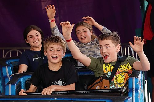 Owen Berry (front left), Noah Hammond (front right), Angelique Berry (back left) and Sophia Berry ride the Himalaya ride during Midway Madness. (Tim Smith/The Brandon Sun)