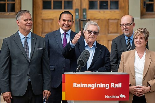 ROBERT LEE / FREE PRESS
Lloyd Axworthy, rail study lead, speaks at the announcement concerning the long-awaited Winnipeg rail relocation at Wesley Hall at the University of Manitoba campus on Wednesday, August 12, 2026.
(From left): MLA Robert Loiselle (St. Boniface); Premier Wab Kinew; Lloyd Axworthy, rail study lead; Minister of Innovation and New Technology, Mike Moroz (River Heights); and Minister of Transportation and Infrastructure, Lisa Naylor (Wolseley).