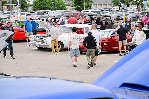 Mike Sudoma/Free Press
Attendees walk down aisles of cars at the Winnipeg Cruise Culture Sunday night
August 9, 2026